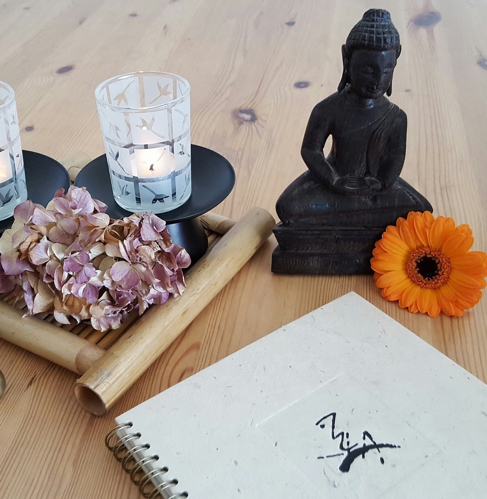 buddha and journal on table